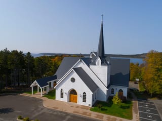 Deep Charcoal Interlock Slate aluminum roof on a white church with a metal roof and a steeple near the, Rothesay, New Brunswick