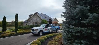 Deep Charcoal Interlock Slate aluminum roof on a stone house with dormers in a rural suburban setting, Sussex, New Brunswick