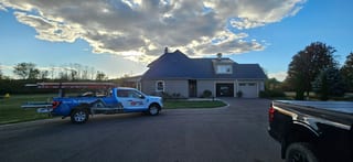 Deep Charcoal Interlock Slate aluminum roof on a two-storey ranch home with dormers and a garage, Sussex, New Brunswick