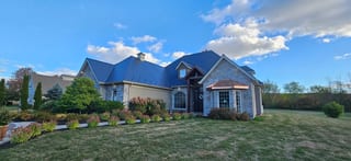 Deep Charcoal Interlock Slate aluminum roof on a ranch style home with a metal roof in a rural area, Sussex, New Brunswick