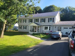 Musket Grey Interlock Slate aluminum roof on a two-storey colonial home with a grey metal roof in a, West Lebanon, New Hampshire