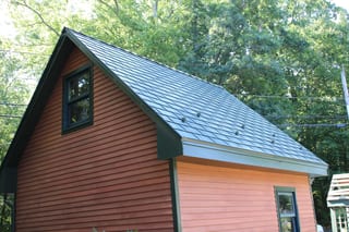 Hunter Green Interlock Slate aluminum roof being installed on the home, replacing an asphalt shingle roof being torn off, Pelham, New Hampshire