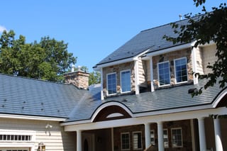 Deep Charcoal Interlock Slate aluminum roof on a colonial style home with a metal roof in a wooded suburb, Center Harbor, New Hampshire