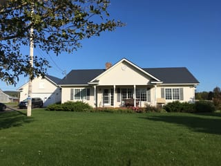 Charcoal Grey Interlock Slate aluminum roof on a white ranch home with a metal roof in a rural setting, Centreville, Nova Scotia
