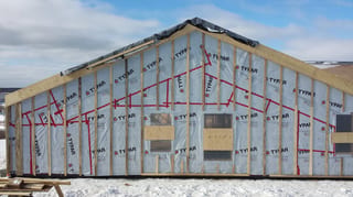 Deep Charcoal Interlock Standing Seam aluminum roof being installed on the home, Cow Bay, Nova Scotia
