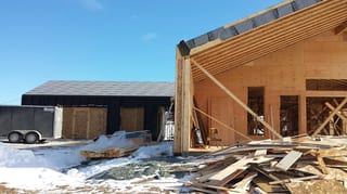 Deep Charcoal Interlock Standing Seam aluminum roof being installed on the home, replacing new construction, Cow Bay, Nova Scotia