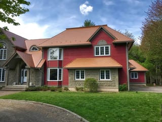 Black Interlock Slate aluminum roof on a red colonial home with dormers and a slate roof in a, Reids Hill (Shelburne), Nova Scotia