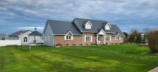 Deep Charcoal Interlock Cedar Shingle aluminum roof on a beige single-storey ranch with a metal roof in a rural, West Dover, Nova Scotia