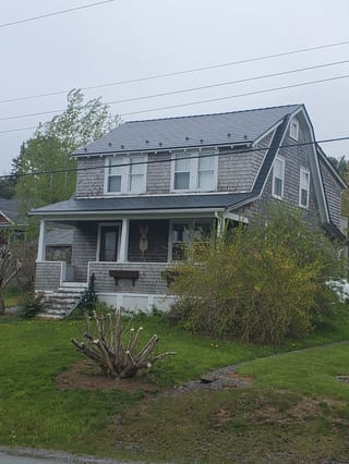 Deep Charcoal Interlock Cedar Shingle aluminum roof on the home, Lunenburg, Nova Scotia