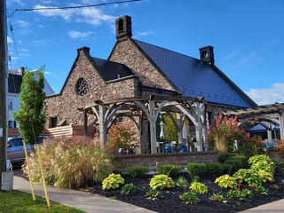 Black Interlock Slate aluminum roof on a heritage-style home with dormers and a slate roof in, Wolfville, Nova Scotia
