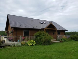 Tudor Brown Interlock Cedar Shingle aluminum roof on the home with roof louver, Darlings Lake, Nova Scotia