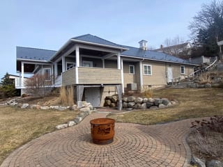 Deep Charcoal Interlock Slate aluminum roof on the home with chimney, Lunenburg, Nova Scotia