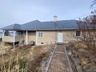 Deep Charcoal Interlock Slate aluminum roof on the home with chimney and roof louver, Lunenburg, Nova Scotia