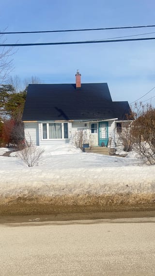 Black Interlock Slate aluminum roof on a white home with a black metal roof in a snowy rural, Meaford, Ontario