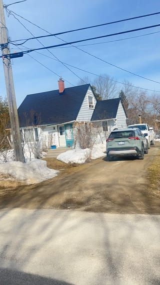 Black Interlock Slate aluminum roof being installed on the home, replacing a worn out asphalt shingle roof, Meaford, Ontario