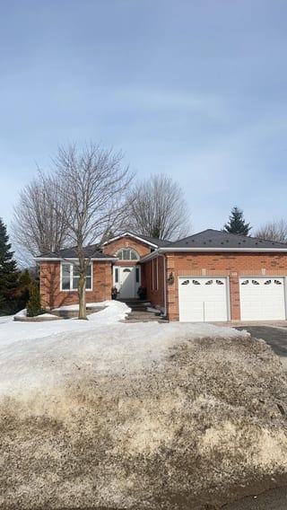 Tudor Brown Interlock Slate aluminum roof on a brown brick home with a metal roof in a suburban, Barrie, Ontario