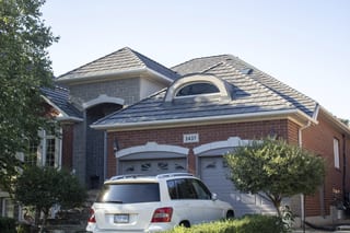 Musket Grey Interlock Shake aluminum roof on a brick home with a white SUV in front, surrounded by trees, Oakville, Ontario