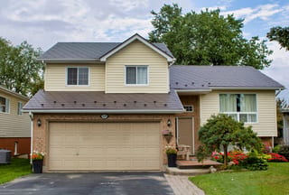 Two-storey suburban home in Shelburne ON with Interlock Tudor Brown aluminum slate metal roofing across multiple roof planes and gable.