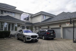 Charcoal Grey Interlock Shake aluminum roof on a white brick house with a garage and a driveway, Whitby, Ontario