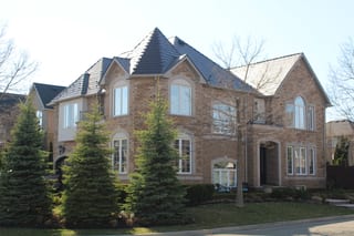Tudor Brown Interlock Cedar Shingle aluminum roof on a Tudor home with a brown roof and stone facade in a, Oakville, Ontario