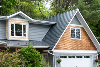 Deep Charcoal Interlock Slate aluminum roof on a grey A-frame home with a metal roof in a wooded lakeside, Algonquin Highlands, Ontario