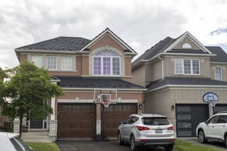 Black Interlock Shake aluminum roof on a beige single-family home with a metal roof in a suburban, Mississauga, Ontario