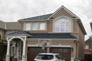 Black Interlock Shake aluminum roof on a brick two-storey home with a garage in a residential, Mississauga, Ontario