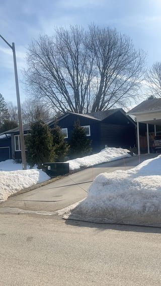 Tudor Brown Interlock Slate aluminum roof on a brown home with dormers in a snowy suburban setting, Thornbury, Ontario