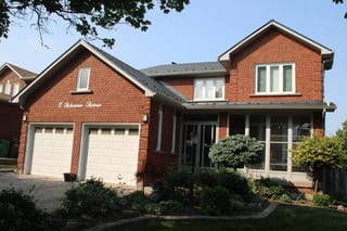 Deep Charcoal Interlock Cedar Shingle aluminum roof on a brick single-family home with a metal roof in a rural, Brampton, Ontario