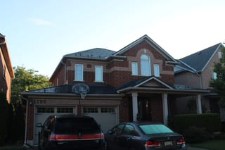 Musket Grey Interlock Slate aluminum roof on a two-storey Colonial home with a Musket Grey metal roof in, Caledonia, Ontario