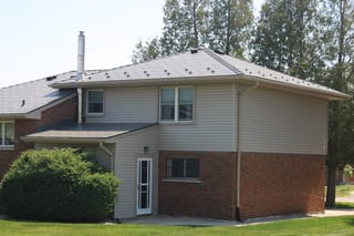 Musket Grey Interlock Cedar Shingle aluminum roof on a two-storey home with dormers and a brick facade, Guelph, Ontario