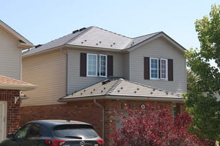 Musket Grey Interlock Cedar Shingle aluminum roof on a grey two-storey home with dormers in a suburban setting, Guelph, Ontario