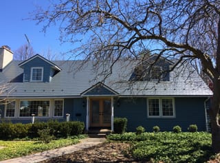 Cape Cod home with Interlock deep charcoal aluminum slate metal roof, twin dormers, snow guards, and blue siding in Niagara on the Lake.
