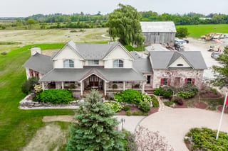Tudor Brown Interlock Cedar Shingle aluminum roof on a Tudor Brown metal roofed two-storey farmhouse with a, Pefferlaw, Ontario