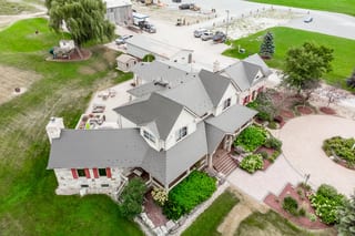Tudor Brown Interlock Cedar Shingle aluminum roof on a Tudor style home in Tudor Brown metal roofing with lush, Pefferlaw, Ontario