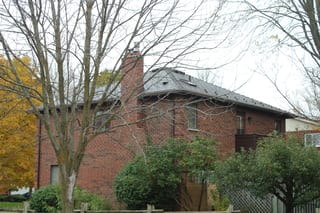 Tudor Brown Interlock Cedar Shingle aluminum roof on a red brick home with a brown metal roof in a residential, Waterloo, Ontario