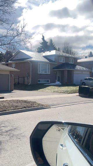 Deep Charcoal Interlock Slate aluminum roof on a two-storey home with dormers among tall pines, Bradford, Ontario