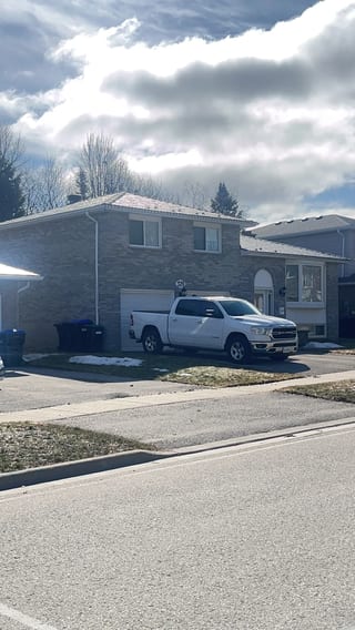 Deep Charcoal Interlock Slate aluminum roof being installed on the home, replacing an asphalt shingle roof being torn off, Bradford, Ontario