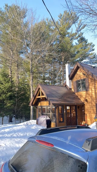 Colonial Brown Interlock Cedar Shingle aluminum roof on a brown chalet-style home with a metal roof in a snowy, Algonquin Highlands, Ontario