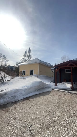 Deep Charcoal Interlock Cedar Shingle aluminum roof on a tan ranch home with a metal roof in a rural suburb, Wasaga Beach, Ontario