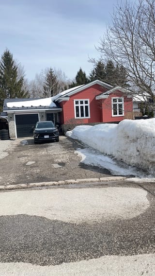 Black Interlock Slate aluminum roof on a red home with a metal roof in a snowy forest, Orillia, Ontario