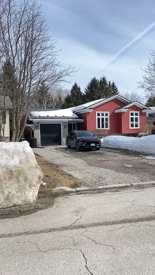 Black Interlock Slate aluminum roof being installed on a red single-storey home with dormers and a metal roof on a, Orillia, Ontario