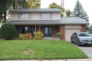 Musket Grey Interlock Cedar Shingle aluminum roof on a two-storey colonial home with a red brick facade and a, Kitchener, Ontario