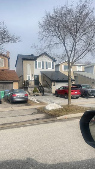 Black Interlock Slate aluminum roof on a two-storey home with a metal roof and a tree in a, Brampton, Ontario
