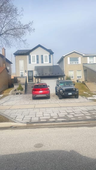 Black Interlock Slate aluminum roof on a tan single-family home with a black metal roof and a grey, Brampton, Ontario