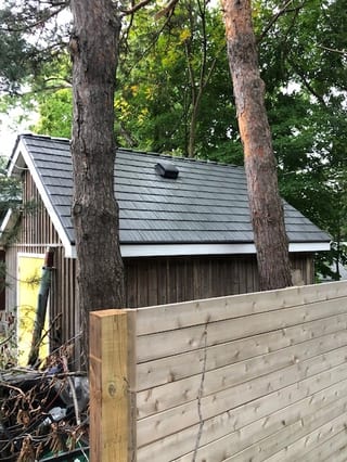 Musket Grey Interlock Cedar Shingle aluminum roof on a modern home with a metal roof in a forested suburban area, Mississauga, Ontario