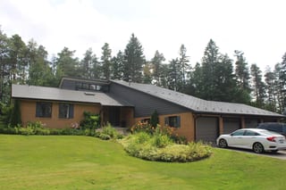 Musket Grey Interlock Cedar Shingle aluminum roof on a brown single-family home with a Musket Grey metal roof in, Mono, Ontario