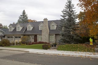 Tudor Brown Interlock Shake aluminum roof on a two-storey Tudor home with dormers and a metal roof in, Waterloo, Ontario