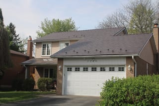 Two-storey suburban home in Mississauga with Interlock Colonial Brown cedar shingle aluminum metal roof, snow guards, double garage, and brick facade.