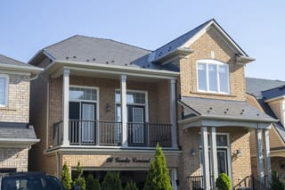 Tudor Brown Interlock Cedar Shingle aluminum roof on a brown two-storey home with dormers and a balcony, Stouffville, Ontario